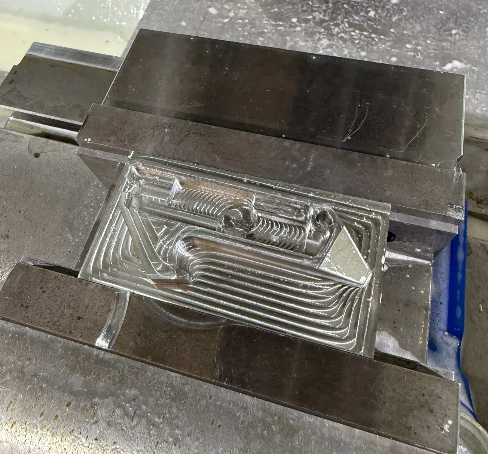 Part mid-CNC held in parallels on the vise
