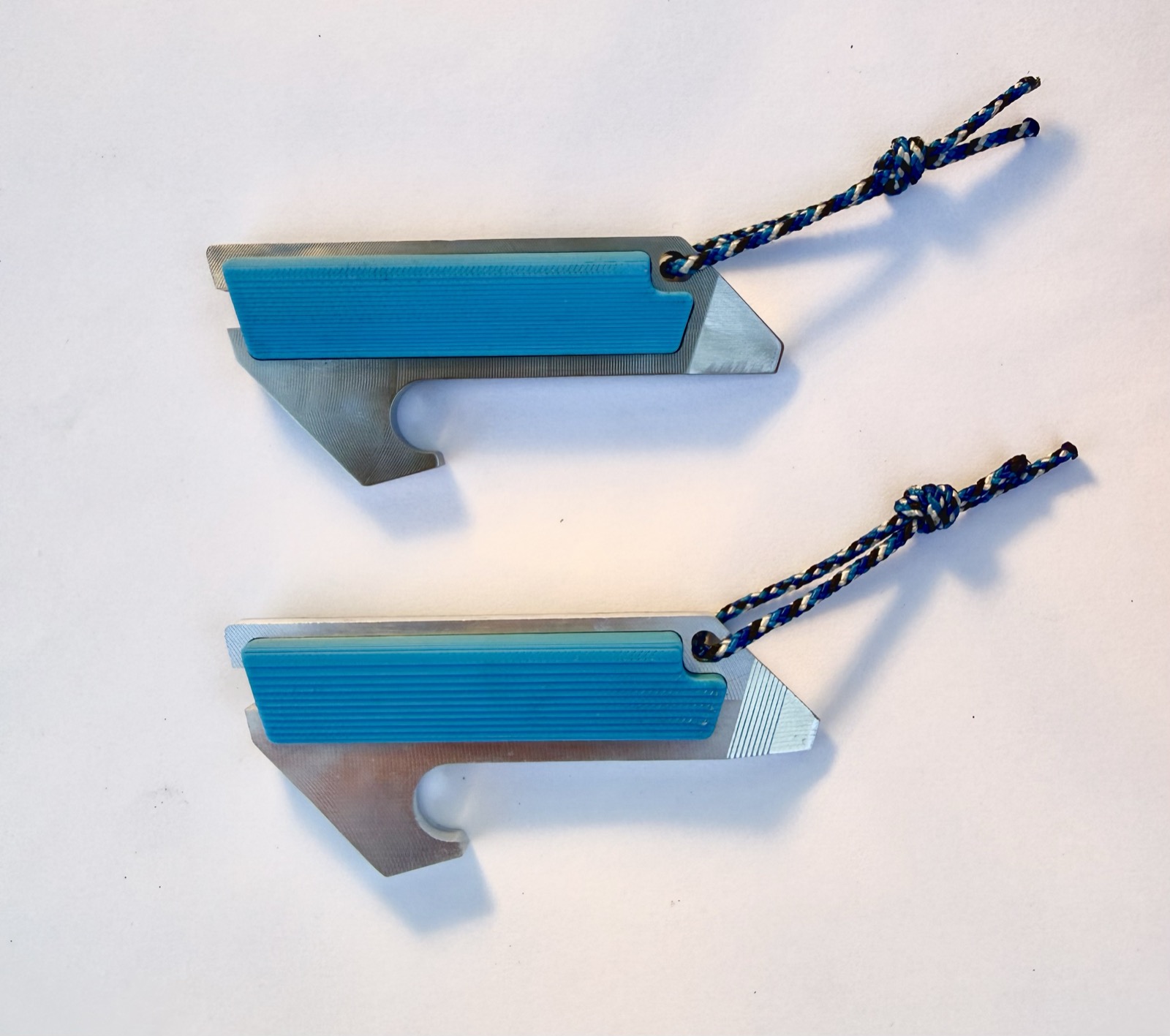 Two finished units with blue PETG scales and paracord lanyards